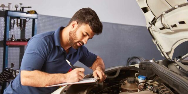An vehicle inspector with a checklist of items to look for