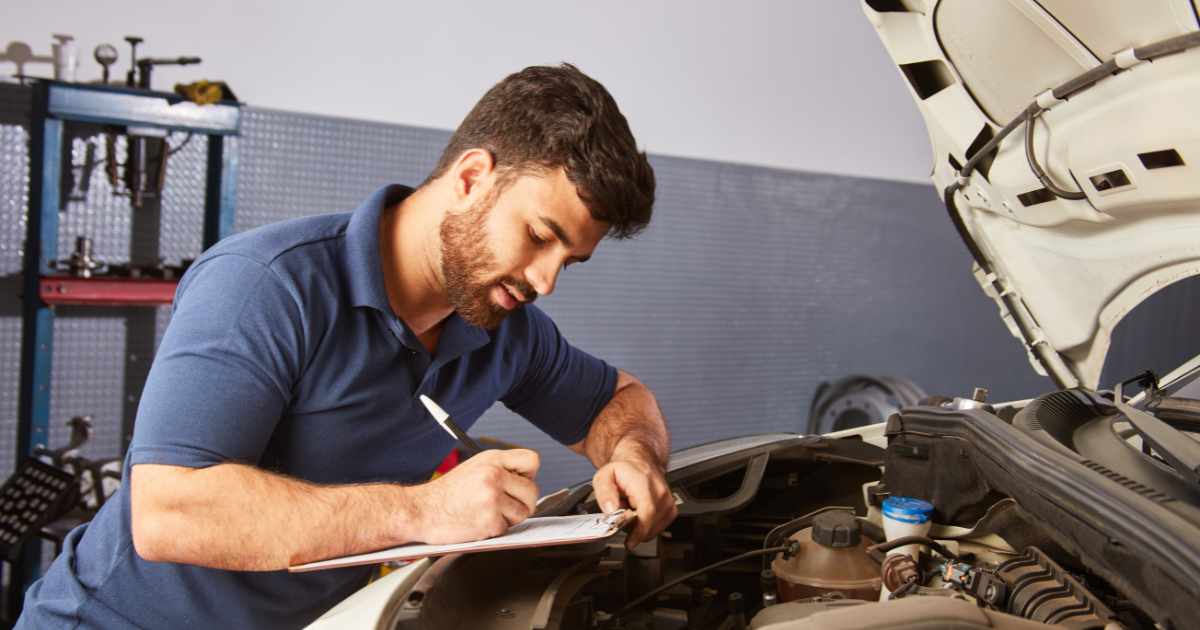 A vehicle inspector with a checklist of items to look for