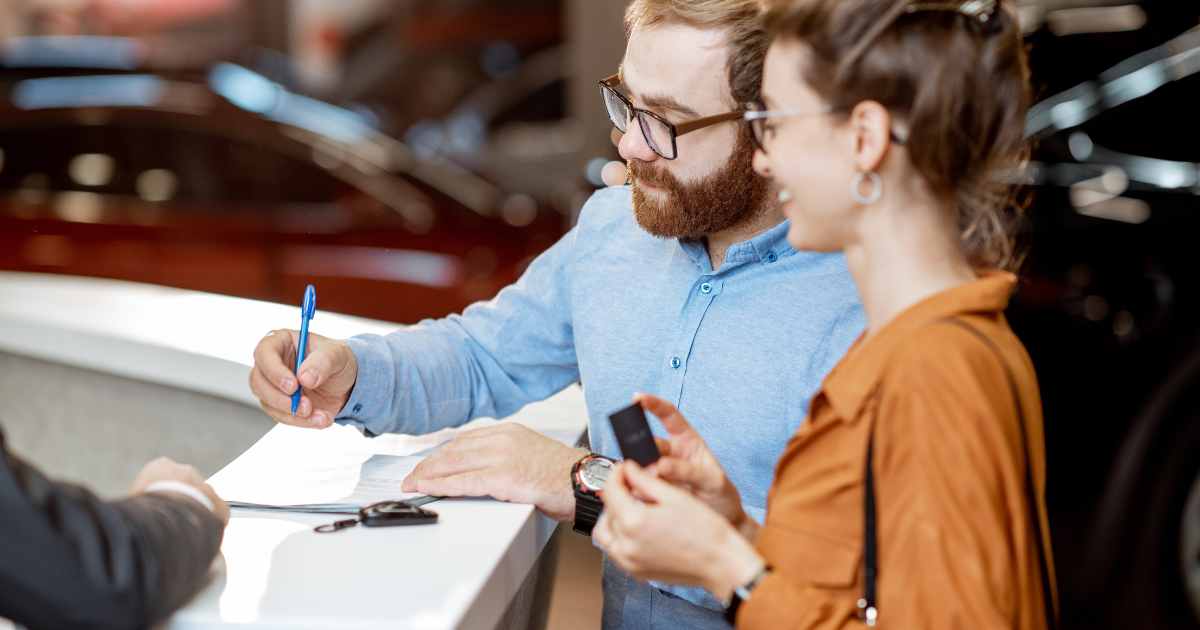 A couple getting their vehicle paperwork in order before they apply for a title loan.